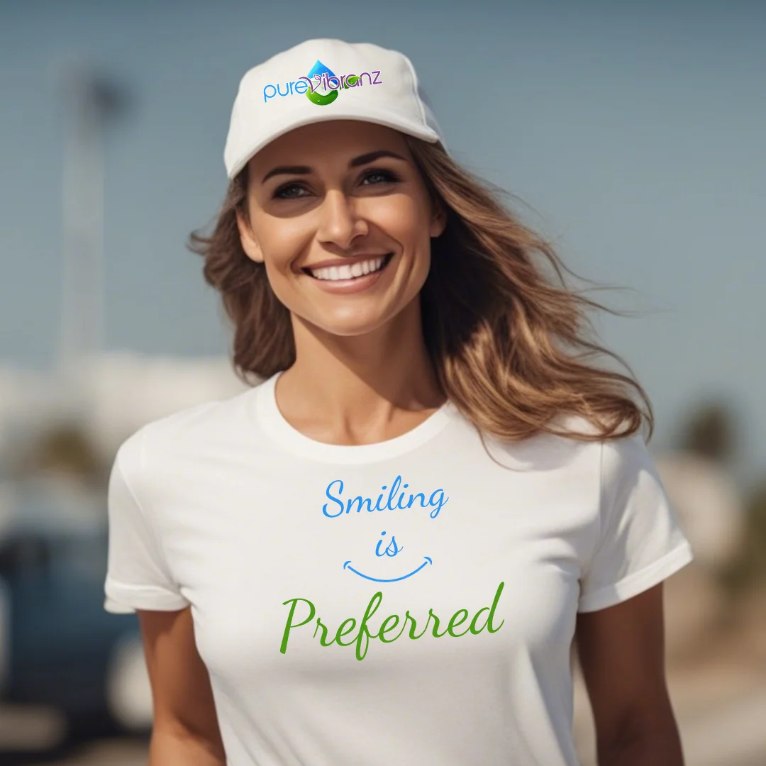 woman wearing a white baseball cap with purevibranz logo, she is also wearing a t shirt saying smiling is preferred to promote the preferred customer program